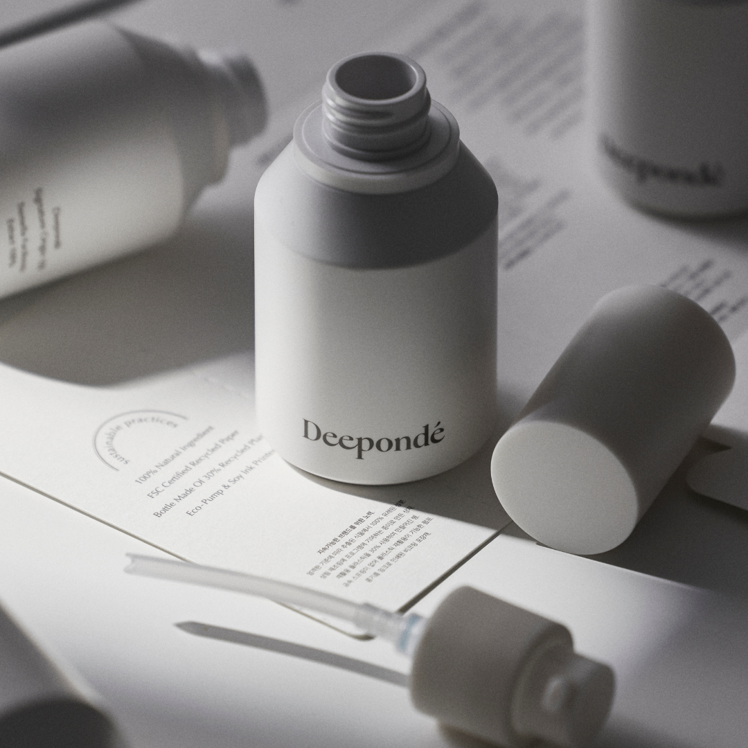 Depondé skincare products on a light surface with a blurred background