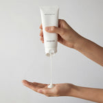Deepondé Signature Origin Cream texture shot — lightweight white cream dispensed from tube